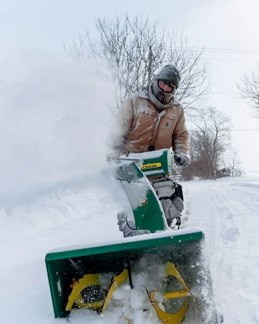 Two-stage snowblower clearing a snowy road