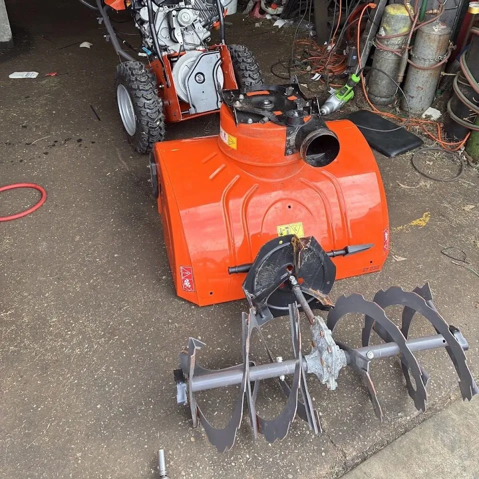 Husqvarna two-stage snowblower with the auger removed for repair